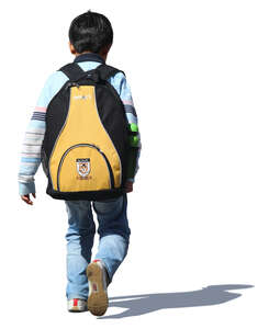 little boy with aschoolbag walking