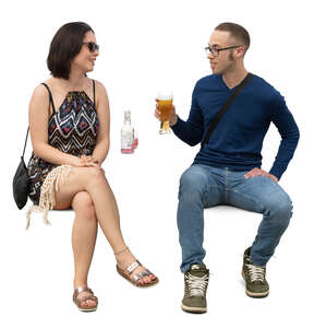 man and woman sitting in a street cafe