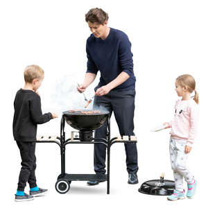 father with two kids cooking dinner on the grill