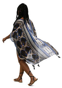 black woman in a beach kaftan walking