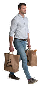 man with two big grocery bags walking
