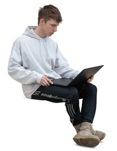 young man with a laptop sitting on a bench