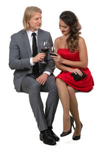 couple sitting in a restaurant and drinking wine