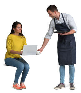 waiter bringing coffee to a woman sitting at a table