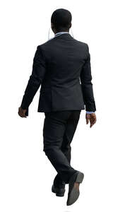 black businessman with earphones walking