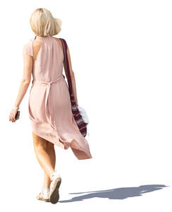 woman in a pale pink dress walking
