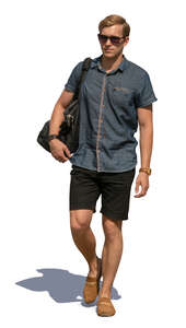 man in summer shorts walking on the street