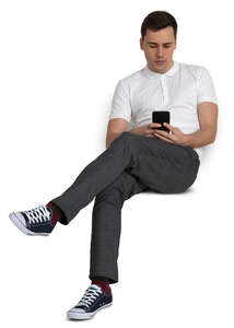 man sitting casually and checking his phone