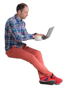 man sitting in a cafe and working with laptop