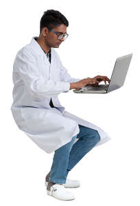 young scientist working at a table with a laptop