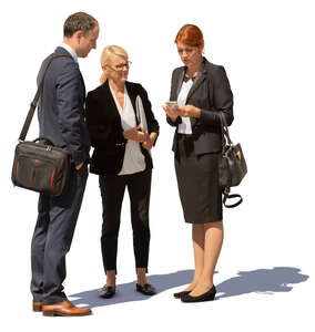 group of three business people standing outside