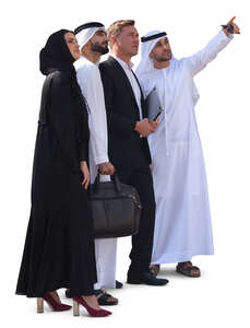 group of businesspeople in emirati standing and looking at smth