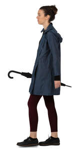 woman with raincoat and umbrella walking