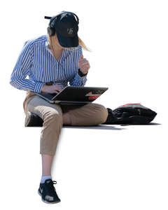 woman with laptop and headphones sitting
