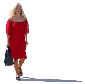 backlit woman in a red dress walking