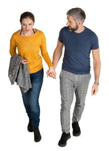 man and woman walking hand in hand seen from above