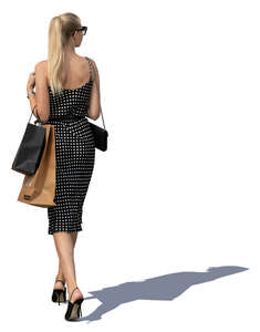 woman with shopping bags walking in sunlight