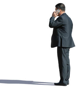 asian businessman standing and talking on a phone