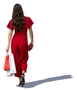 woman in a red jumpsuit walking shopping bags in hand