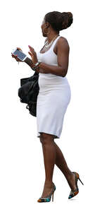 black woman in a white summer dress walking