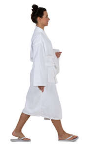 woman in a white bathrobe walking