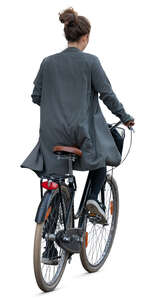 woman in a grey jacket riding a bike