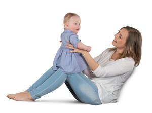 woman sitting on a sofa and playing with her baby girl