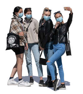 four girls with face masks standing and taking a selfie