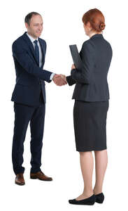 man and woman shaking hands at a business meeting