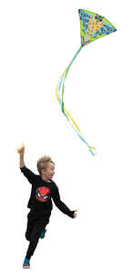 little boy running and flying a kite
