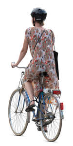 woman in a summer dress riding a bike