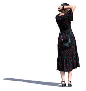 woman in a long summer dress standing and looking around