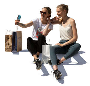 two young women sitting on stairs and taking a selfie