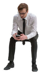 cut out businessman sitting and browsing his phone