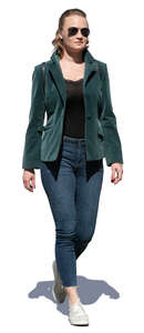 cut out woman in a green jacket walking