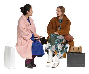 cut out two women in overcoats sitting and talking