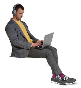 cut out man with headphones and a laptop sitting