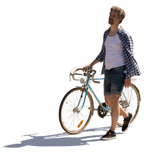 cut out backlit man walking while pushing a bike