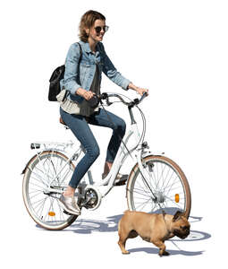 cut out woman riding a bike with a dog running beside her