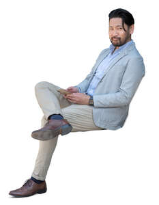 cut out asian man sitting and looking around