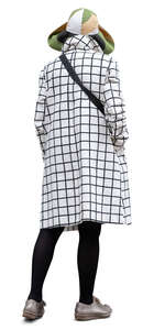 cut out woman with an overcoat and large hat standing