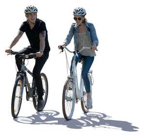 cut out backlit image of a man and woman riding a bike