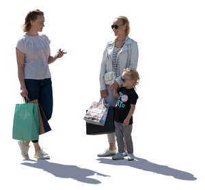 two cut out women and a little boy standing and talking