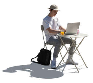 young man sitting in a cafe and working with a laptop