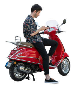 cut out man sitting on a red vespa scooter