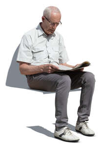 cut out elderly man sitting and reading a newspaper