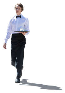cut out backlit young male waiter carrying a tray walking