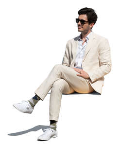 cut out man in a white suit sitting