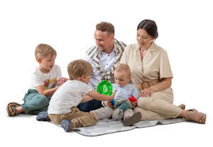 cut out family with three kids playing on the picnic blanket