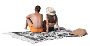 cut out man and woman sitting on the beach